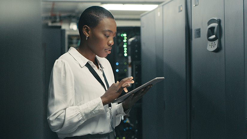 Shot of a young woman using a digital tablet while working in a data centre