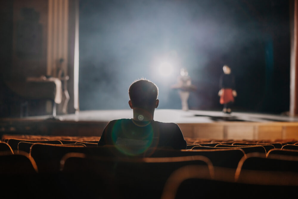One spectator watching the rehearsal of ballet dancer on stage