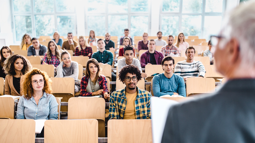 Large Group of College Students Listening to Their Professor