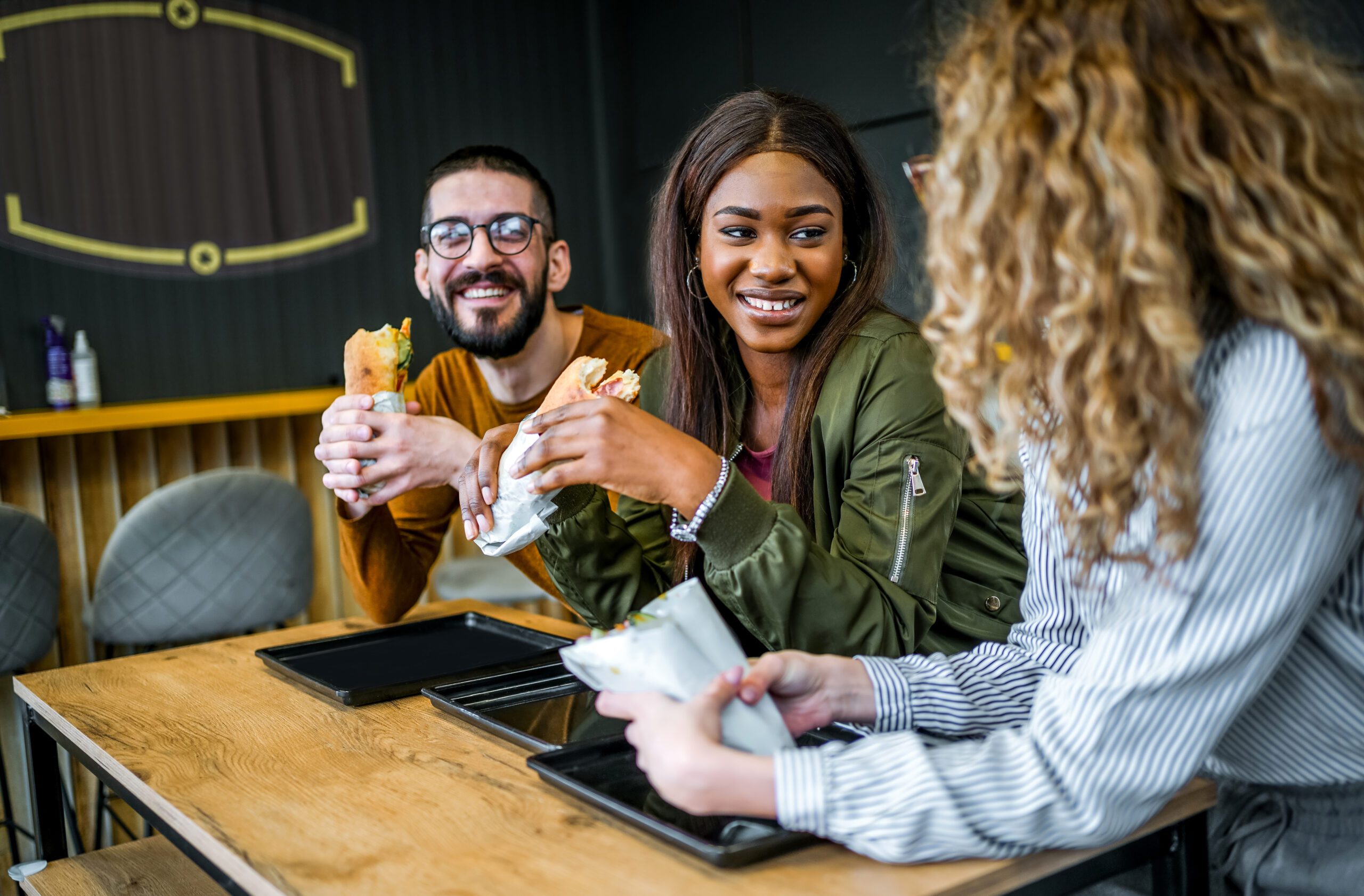 Friends having lunch together in a fast-food restaurant
