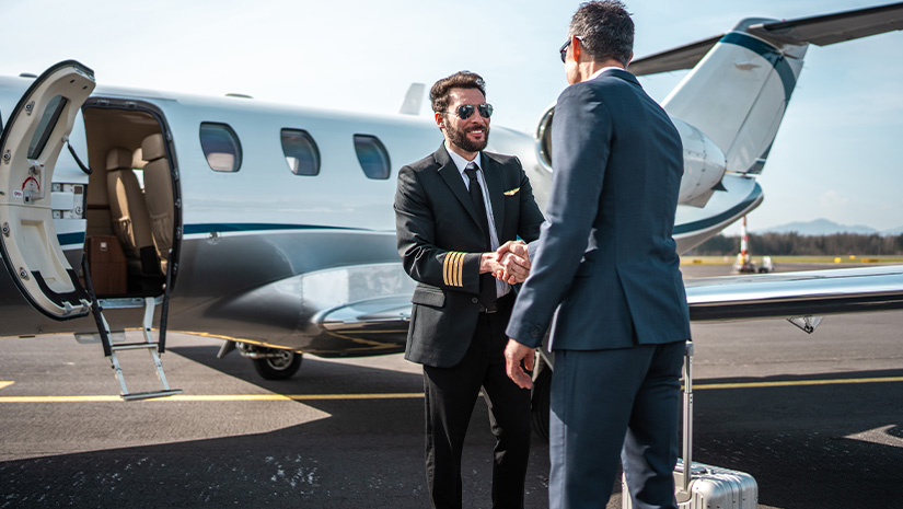 Pilot Handshake with Asian Business Executive at Airport